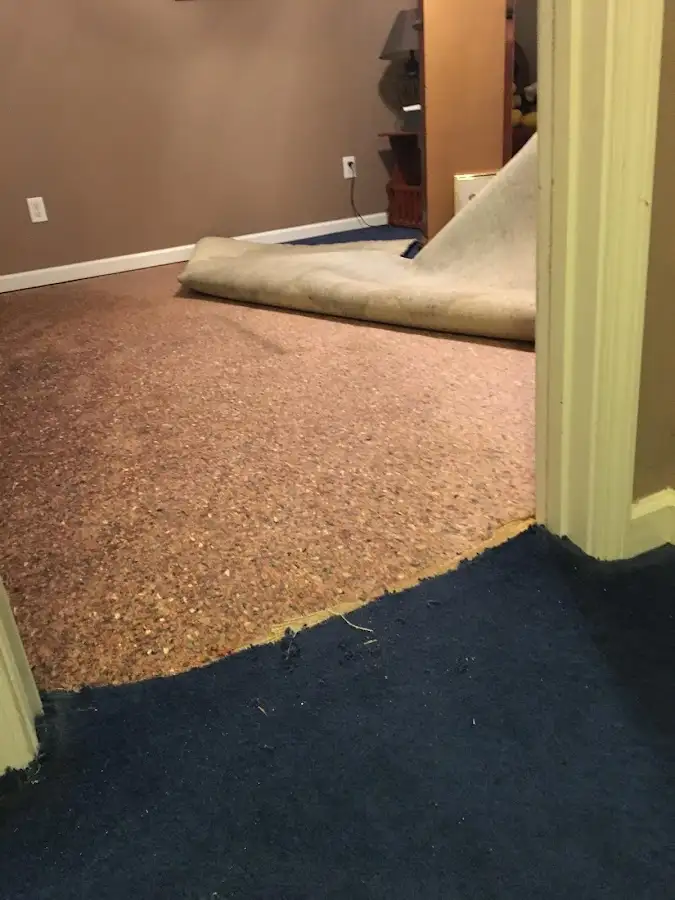 Carpet pad removal revealing water damage during Drying & Dehumidification in Ayer