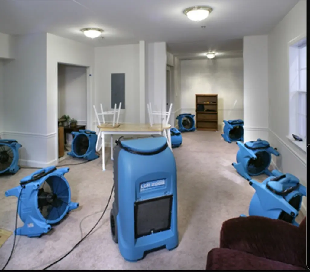 Air movers and dehumidifier setup for Water Damage Restoration in Ayer